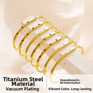 Detailed macro view of 18k gold plated titanium cuff bangle with colorful zircon stones