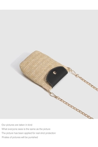 Detailed macro view of woven straw texture with black leather flap and golden metal clasp