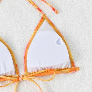 Detail of orange tie-dye bikini top showing white removable chest pads and soft lining