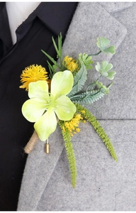 Detail of a handmade green boutonniere with jute-wrapped stem on a grey suit lapel