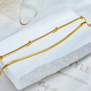 Double-layered gold stainless steel anklet with snake chain and beads on stone base
