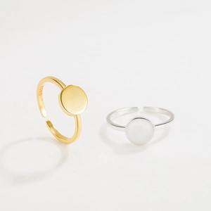Detail of adjustable S925 sterling silver rings in gold and silver finishes on white