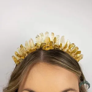Macro detail of natural raw citrine crystals and golden metal leaves on a bridal headband