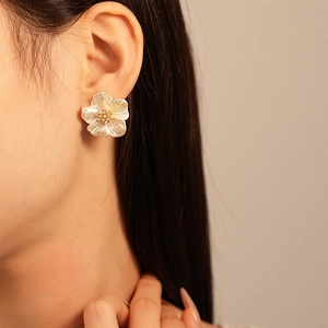 Elegant floral stud earrings with pearlescent white petals and small gold bead accents