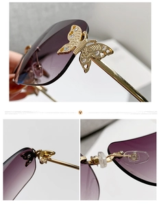 Detail of metal butterfly decoration with crystals on purple gradient rimless sunglasses