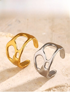 Detailed view of 18K gold and silver irregular open rings with liquid metal texture