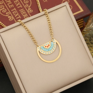 Detailed close-up of a gold bohemian fan-shaped necklace with turquoise and red stones