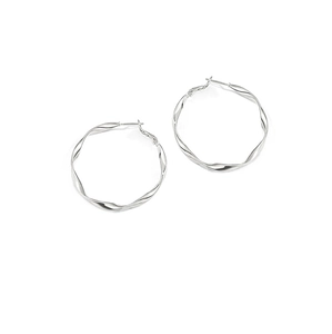 Macro shot of silver twisted hoop earrings with a textured metal surface finish