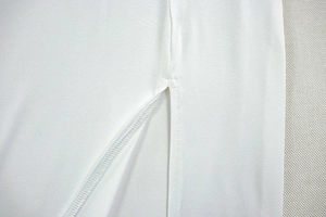 Detail showing the white slit dress design with professional stitching and high-quality fabric