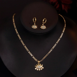 Gold plated evil eye necklace and earrings set with blue zircon on mannequin