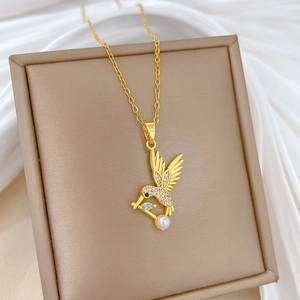 Détail du collier colibri doré avec perle blanche et cristaux étincelants