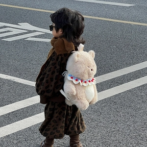 Cute beige plush bear backpack for kids featuring blue and red lace collar details