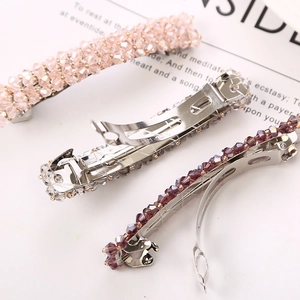 Handcrafted beaded spring hair clips in pink and purple colors with French clip base