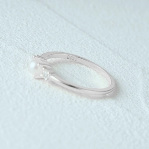 Macro shot of S925 sterling silver ring showing pearl setting and small diamond details