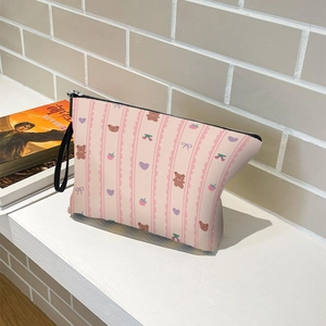 Pink striped cosmetic bag with bear and cherry patterns, featuring a black zipper and strap