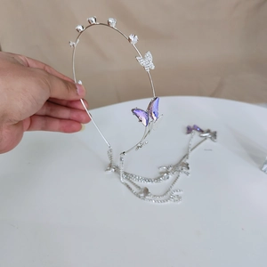 Elegant silver rhinestone headband with purple butterfly design and hanging tassel chains