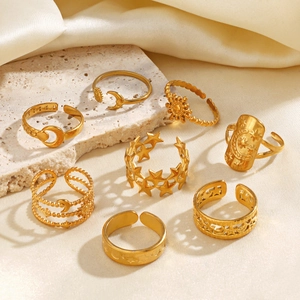 8-piece set of gold star and moon open rings in bohemian style on silk and stone background
