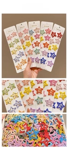 Macro shot of colorful star-shaped Y2K hair clips on white display cards for girls