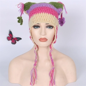 Detailed close-up of handmade striped knit cat ear hat with long braided tassels