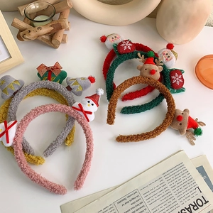 Detail showing four different Christmas plush headbands with reindeer, Santa, and tree designs