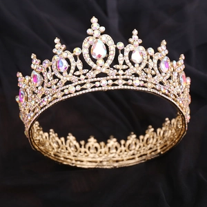 Close-up of golden bridal crown featuring AB rhinestones and intricate floral metalwork