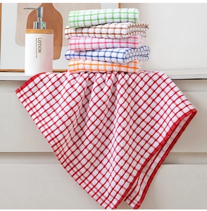 Close-up of assorted colorful checkered cotton tea towels neatly stacked on a rack