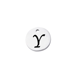Close-up of a polished round stainless steel pendant with an engraved black letter Y