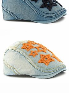 Detail of embroidered star patch on vintage wash denim flat cap for men and women