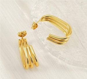 Detail of 18K gold-plated stainless steel triple line earrings on silk background