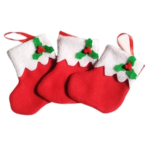 Three felt Christmas stockings in red and green with holly leaf details for table decor