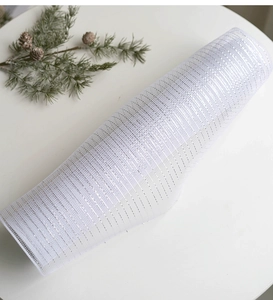 Detail of white deco poly mesh roll with silver metallic foil for Christmas DIY decoration