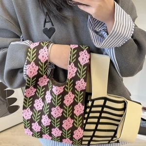 Minimalist knit floral and checkered wrist bags with thick elastic texture in cozy setting