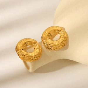 18k gold plated stainless steel hoop earrings with hammered texture on white ceramic vase