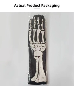 Close-up of Halloween skeleton gloves in clear retail packaging with white bone print