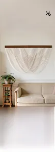 Close-up of bohemian hand-woven cotton macrame wall hanging with wooden support