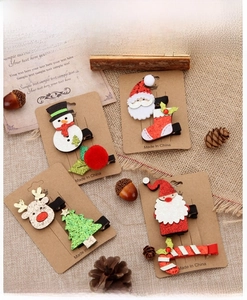 Detail showing Christmas hair clips with Santa, reindeer and tree motifs on cards