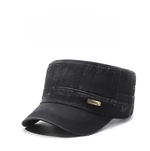 Detail view of washed denim military cap with metal brand plaque and air vents