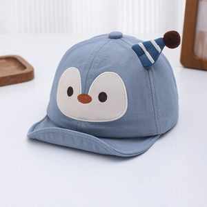 Detail of baby sun hat with cute penguin face embroidery and mini pom-pom on top
