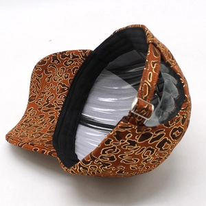 Detail of leopard print baseball cap featuring an adjustable metal buckle and inner sweatband