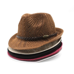 Detailed knit texture of stacked fedora hats with leather bands and metal buckles