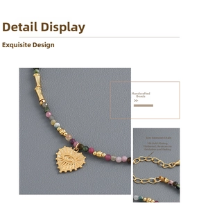 Detail of beaded tourmaline necklace with gold heart pendant and 5cm extension chain