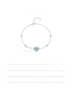 Detail of s925 silver heart bracelet with green enamel and faceted crystal stone