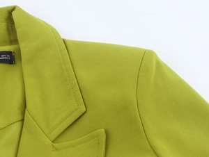 Detail of green blazer collar showing textured fabric and size label from Morocco