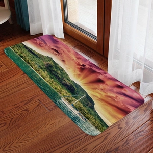 Close-up of a scenic flannel floor mat featuring sunset and mountains on wooden floor