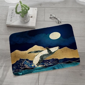 Artistic whale and golden mountain flannel door mat on a light grey wooden floor