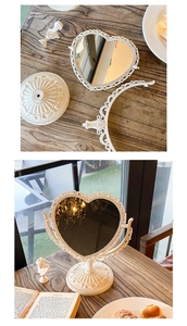 Detail view of heart-shaped vintage desk mirror with ornate embossed floral carvings