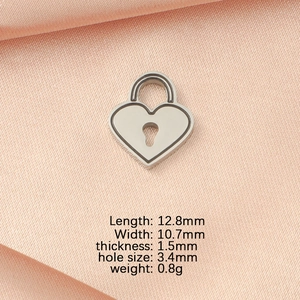 Detailed dimensions of silver heart lock pendant with measurements on pink silk fabric