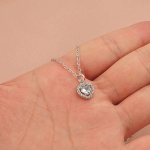 Elegant silver heart necklace with light blue gemstone and zircon halo on thin chain