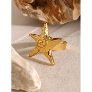 Detailed macro shot of 18k gold starfish ring with spiral texture and open band design