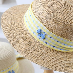 Women's wide brim straw sun hat with gingham ribbon and blue dog ornament decoration